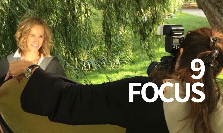 Frau beim professionellen Fotoshooting im Grünen – Symbol für Fokus, Klarheit und Gene Key 9 im Business.